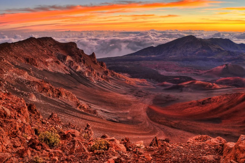 8928409 - volcanic crater landscape with beautiful orange clouds at sunrise taken at haleakala national park in maui, hawaii.