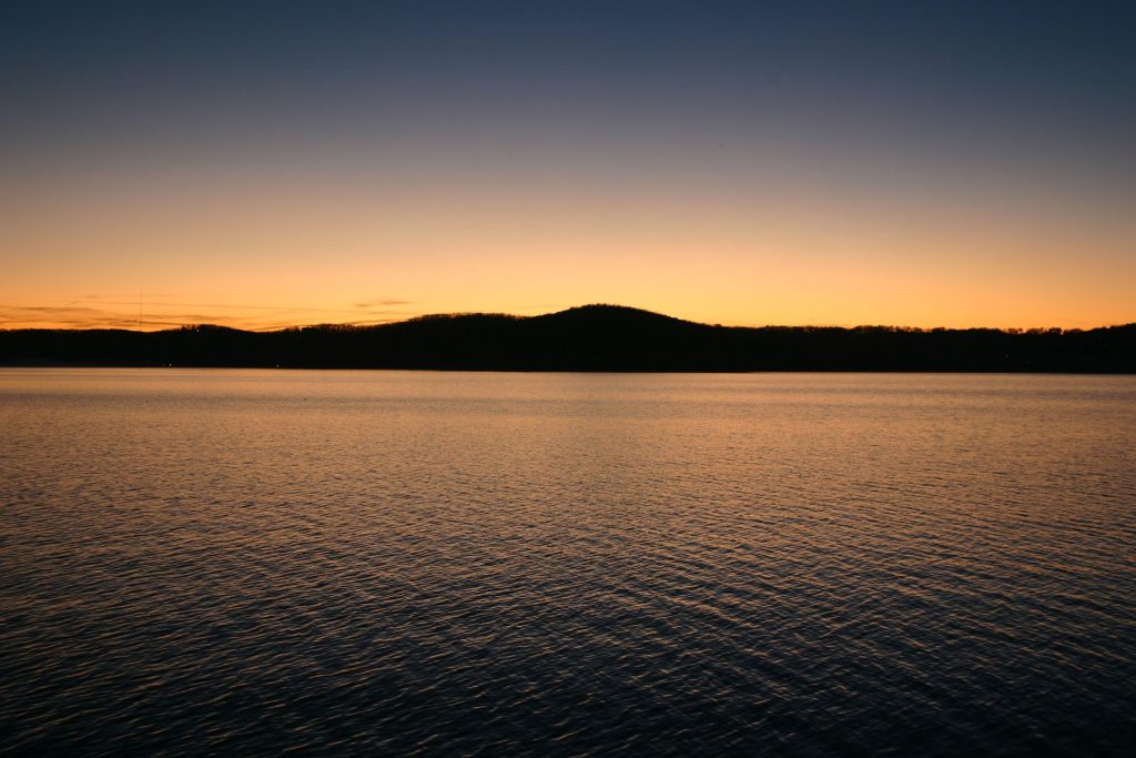 21535078 - a twilight glow after sunset reflects over table rock lake, missouri