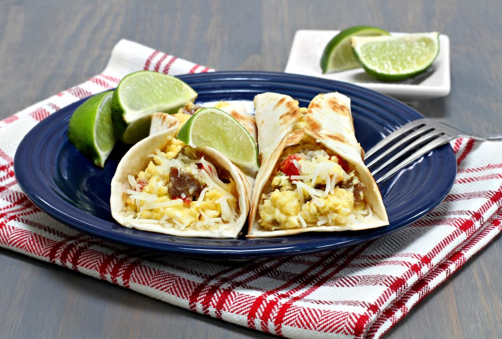 46190993 - two egg, sausage, pepper, onion and cheese breakfast tacos.