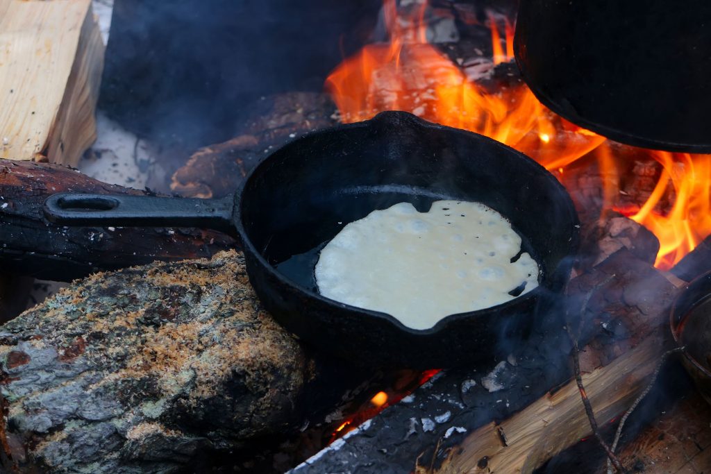 pancake cooking on campfire